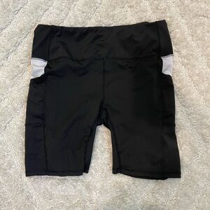 Black biker shorts with white detail and pockets